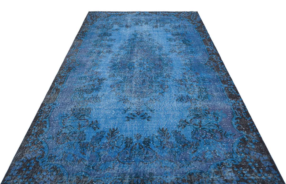 Blue and black distressed traditional rug with a central medallion and ornate border on a white background.