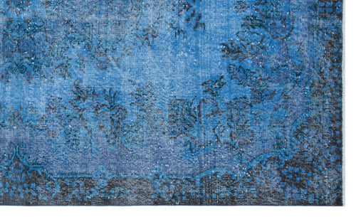 Load image 1 in gallery view. Blue and black distressed rug with a faded floral medallion pattern on a white background.