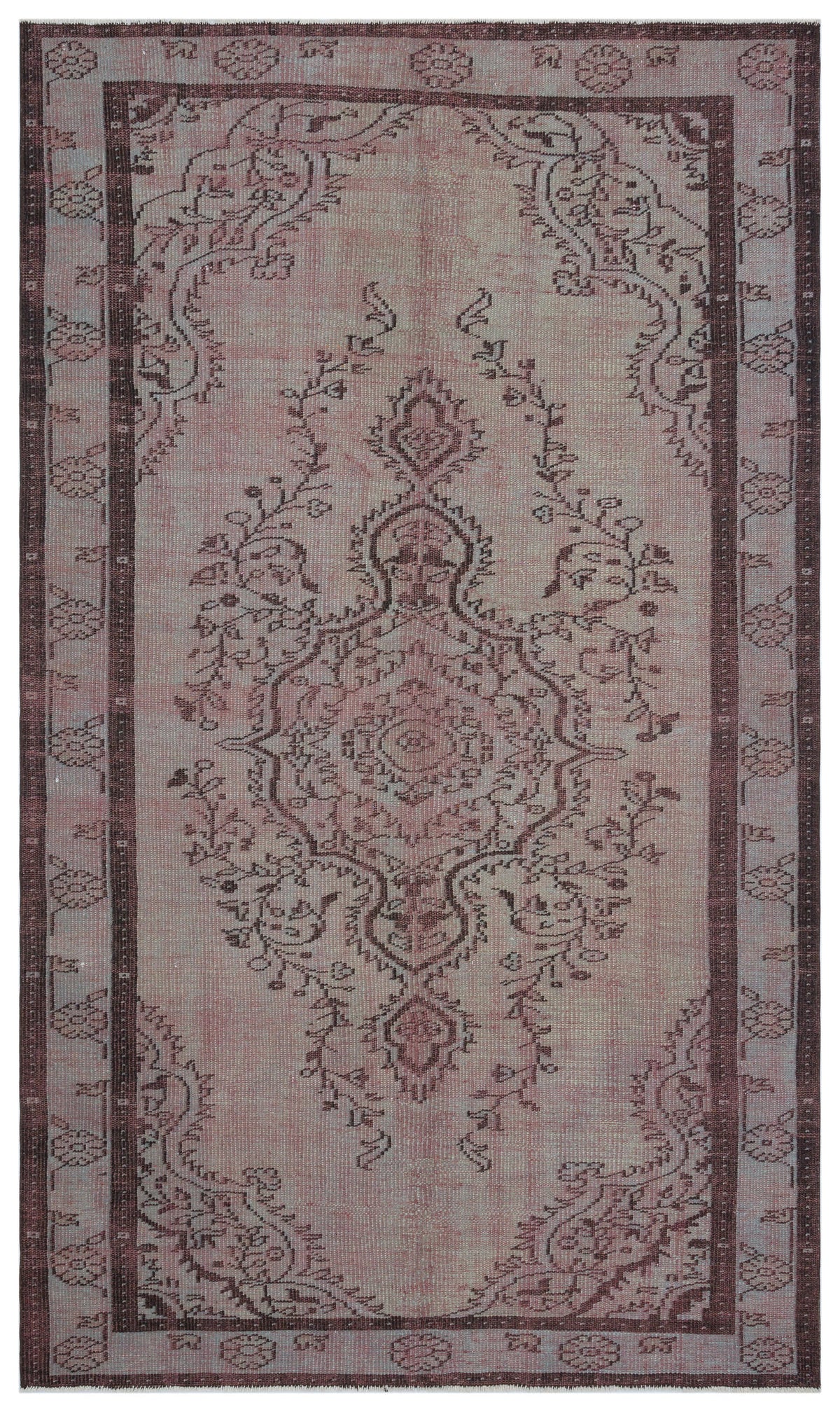 Faded dusty rose and dark brown vintage-style rug with a central floral medallion and a decorative border.