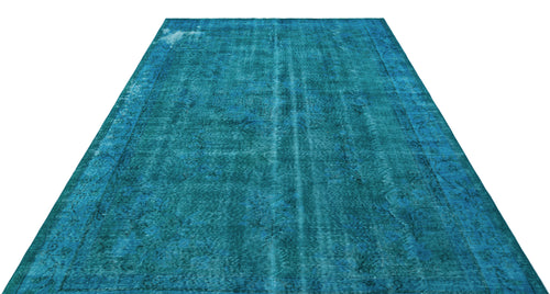 Load image 1 in gallery view. Teal distressed overdyed rug with a faint traditional floral medallion pattern and a bordered edge.