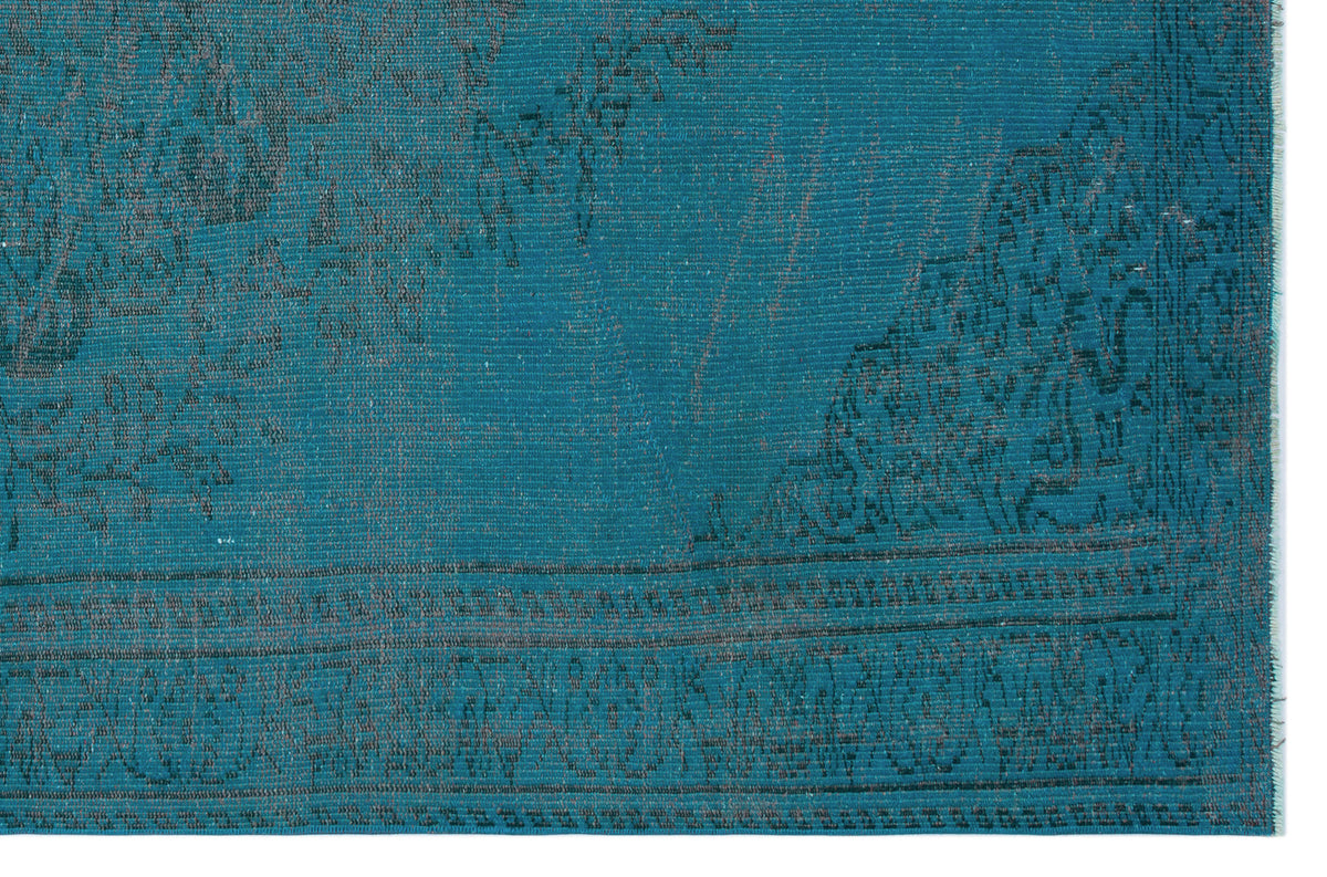 Teal rug with a distressed, dark grey traditional medallion pattern and a detailed border.