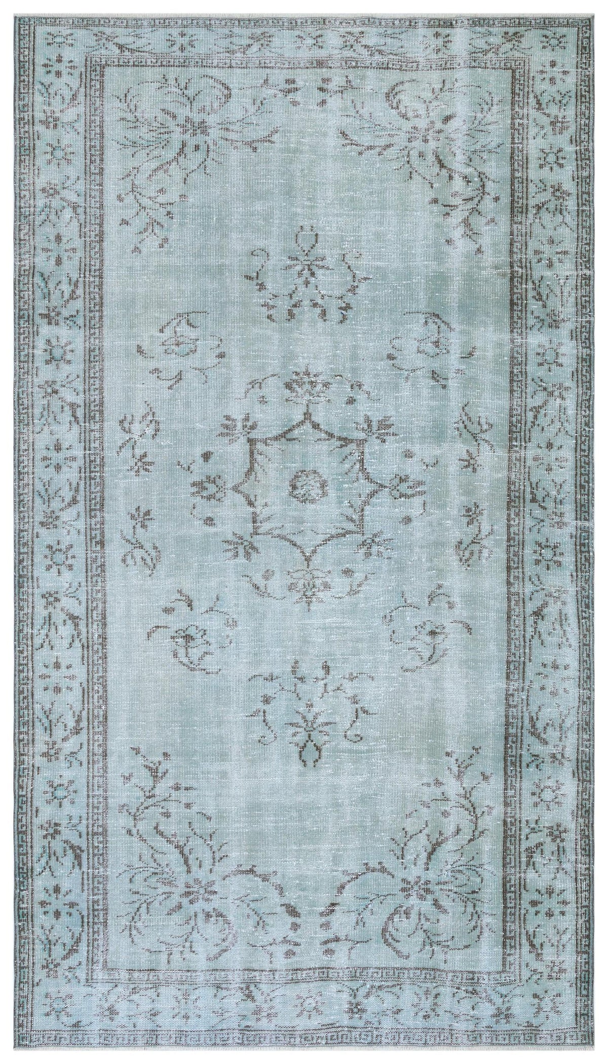 Light blue distressed rug with a dark grey floral medallion and a decorative border.