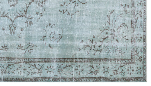 Load image 1 in gallery view. Light blue distressed rug with a faded brown floral pattern and a geometric border.