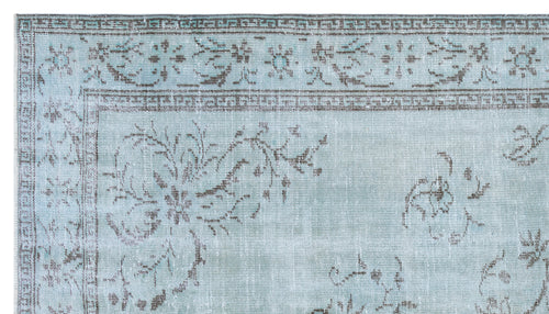 Load image 1 in gallery view. Light blue and grey distressed rug with a traditional floral medallion pattern and a geometric border.