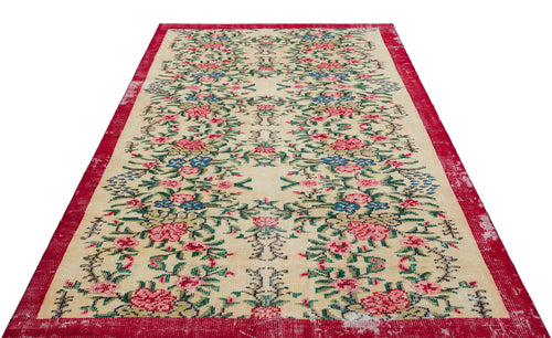 Load image 1 in gallery view. Cream rug with a red border and a repeating floral pattern in pink, blue, and green on a white background.