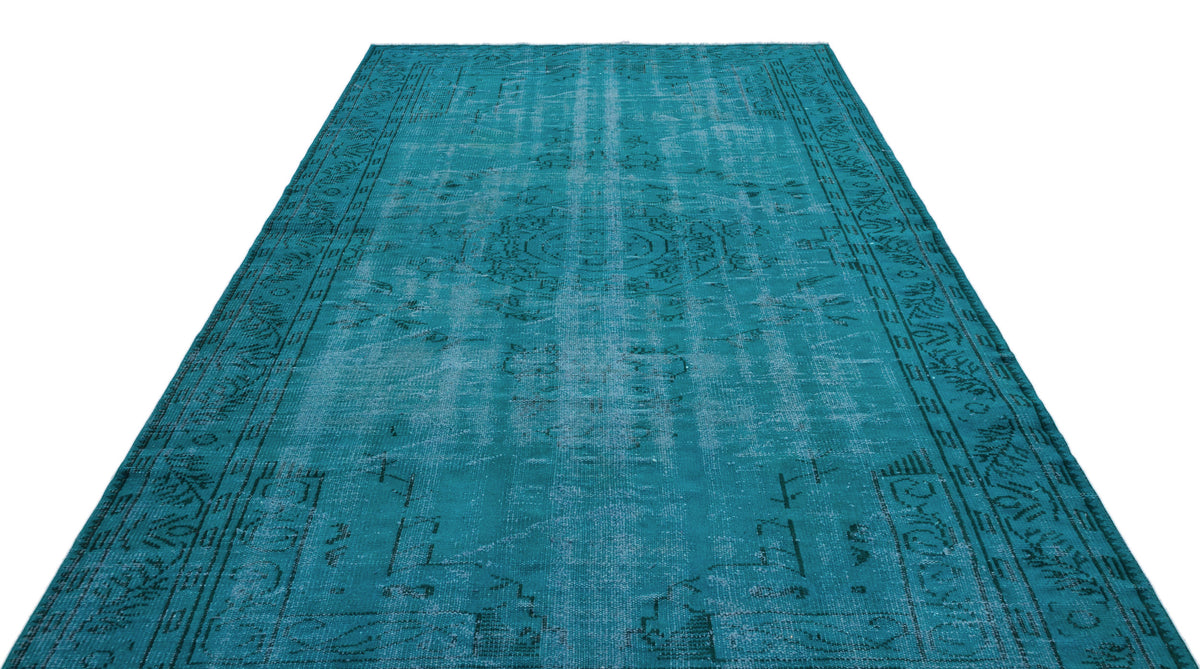 Teal distressed area rug with a faded traditional medallion pattern and ornate border on a white background.