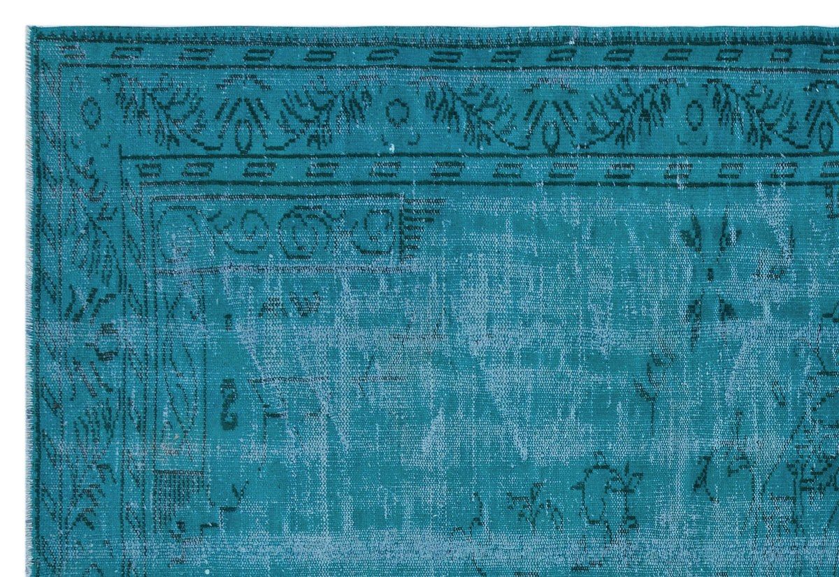 Teal and light blue distressed rug with a traditional border and faded ornamental pattern on a white background.