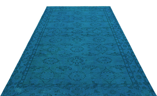 Load image 1 in gallery view. Bright blue rug with a dark, repeating floral medallion and geometric border pattern on a white background.
