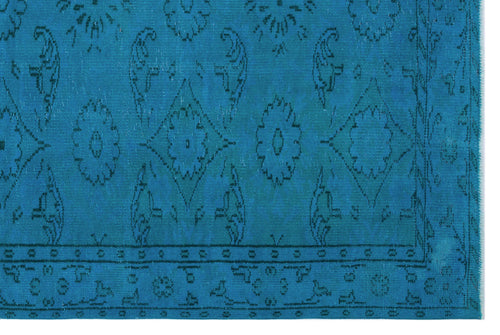 Load image 1 in gallery view. Bright blue rug with a dark blue distressed floral medallion pattern and a geometric border.