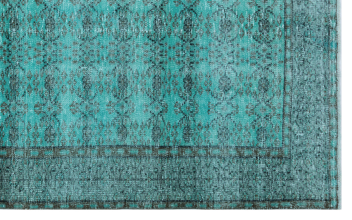 Teal and charcoal distressed rug with a traditional medallion pattern and a geometric border.