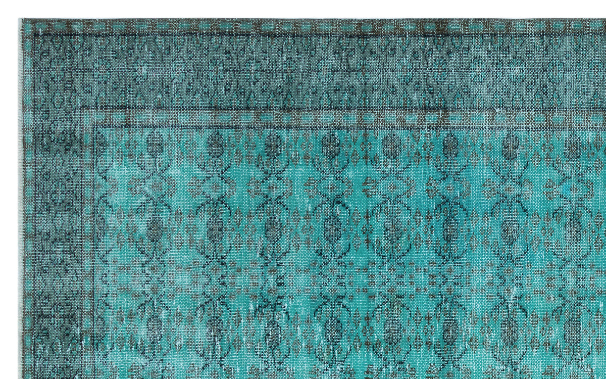 Teal and charcoal distressed rug with a traditional ornate medallion pattern and a wide decorative border.