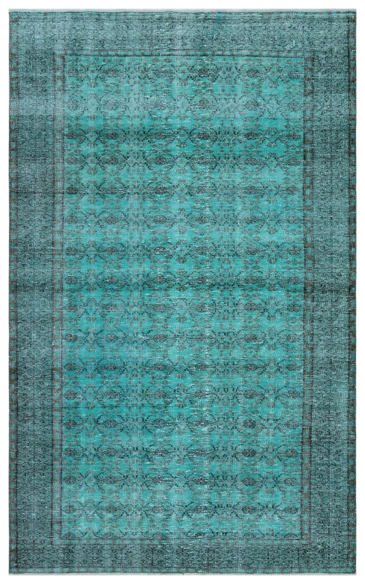 Teal and charcoal distressed rug with a repeating geometric medallion pattern and a bordered edge.