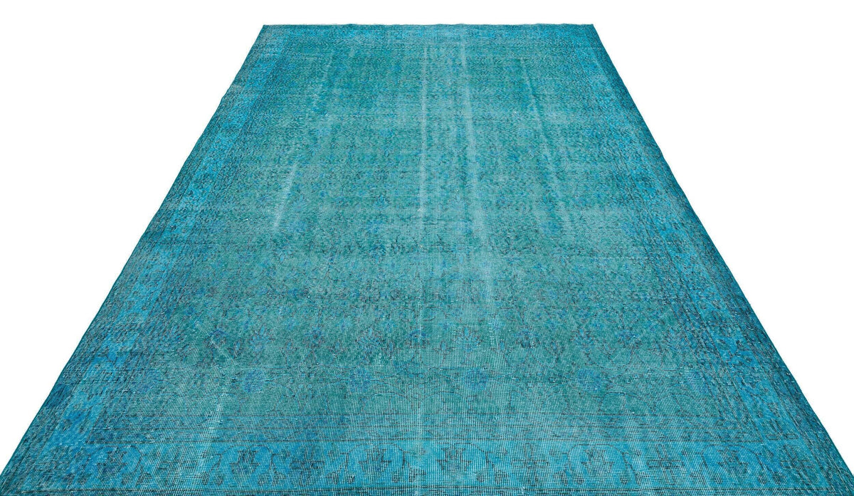 Teal distressed vintage-style rug with a faded traditional medallion pattern on a white background.