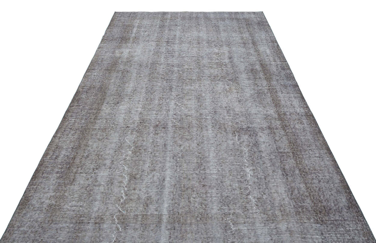 Charcoal and grey distressed vintage-style rug with a subtle, faded linear texture on a white background.