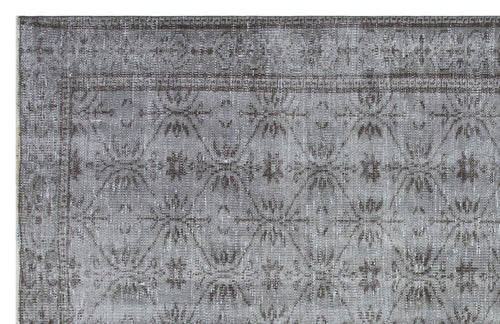 Load image 1 in gallery view. Grey and charcoal distressed rug with a repeating geometric diamond and floral medallion pattern.