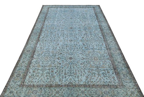 Load image 1 in gallery view. Light blue traditional rug with a dark brown floral vine pattern and a matching border on a white background.