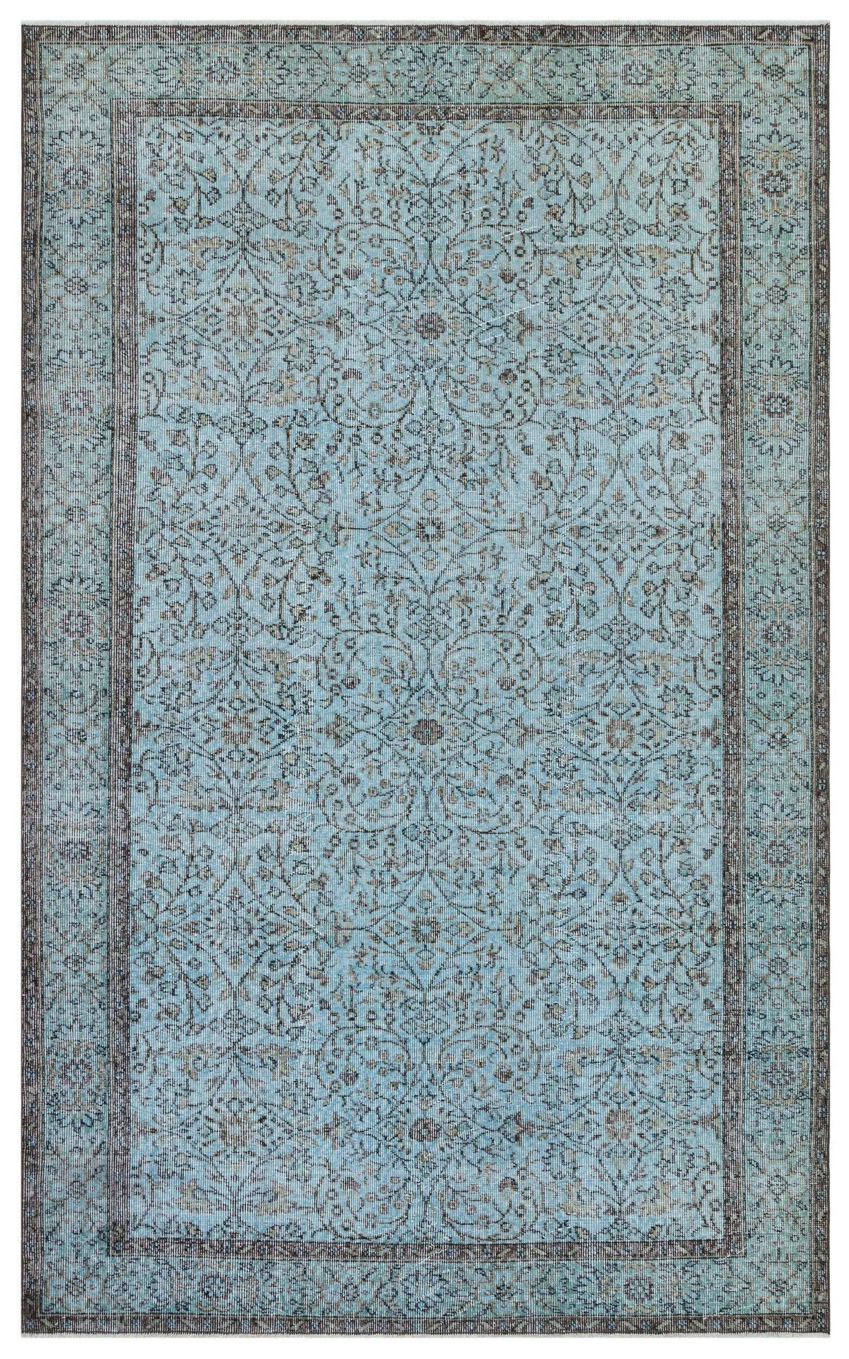 Light blue and charcoal grey traditional rug with an intricate floral vine pattern and a wide decorative border.
