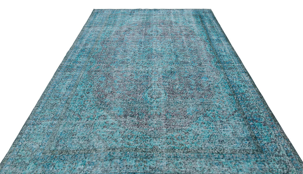 Teal and charcoal distressed vintage-style rug with a faded traditional medallion pattern on a white background.