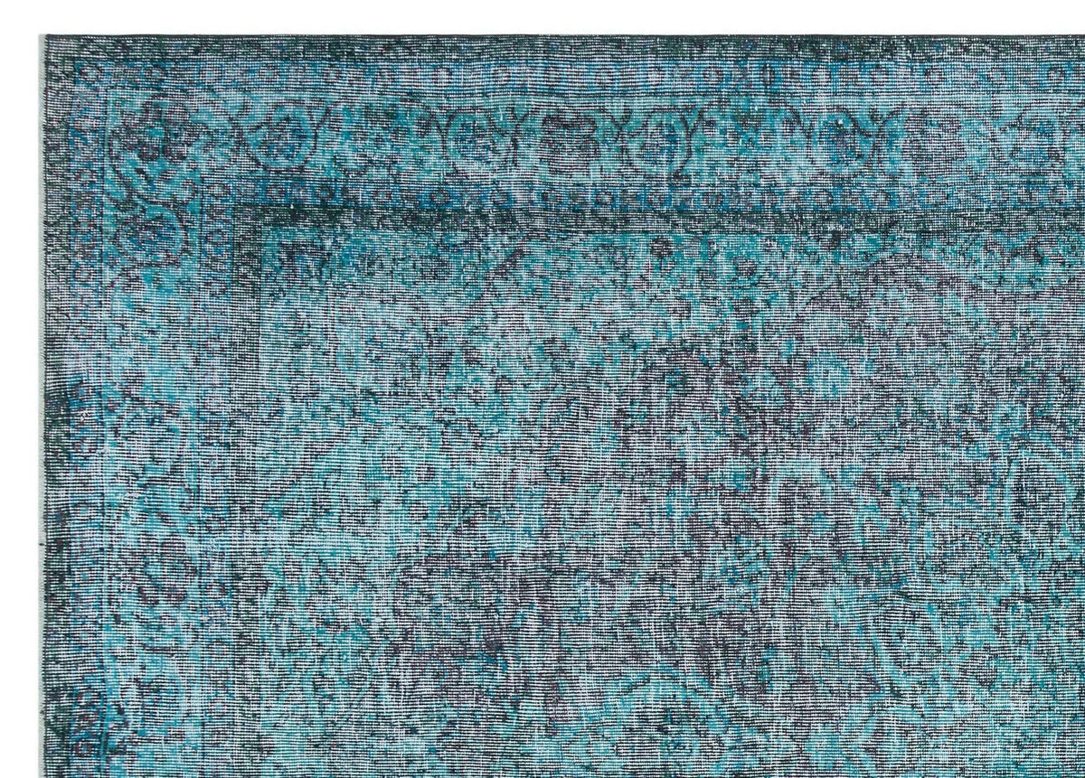Teal and dark blue distressed rug with a traditional ornate border and faded vintage-style pattern.