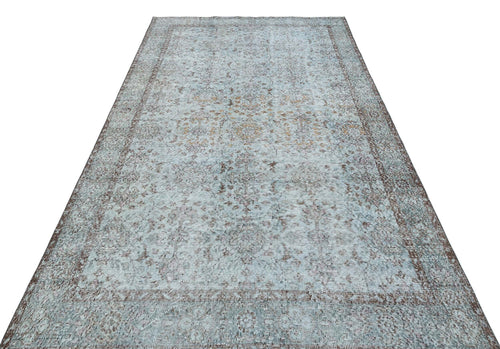 Load image 1 in gallery view. Light blue and brown distressed vintage-style rug with a traditional floral medallion pattern on a white background.