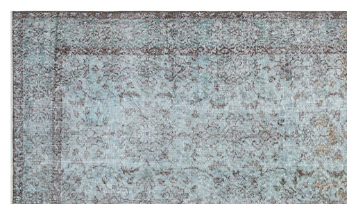 Load image 1 in gallery view. Light blue and brown distressed rug with a traditional floral medallion pattern and a wide decorative border.
