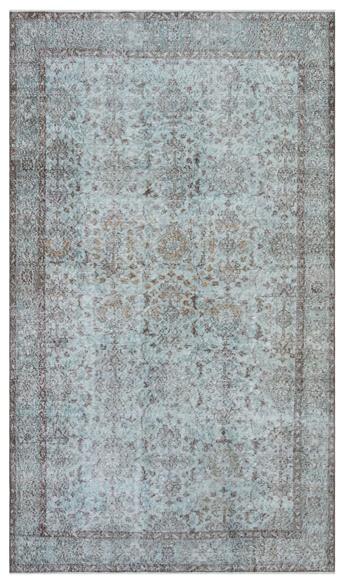 Light blue and brown distressed traditional rug with a faded floral medallion pattern and a bordered edge.