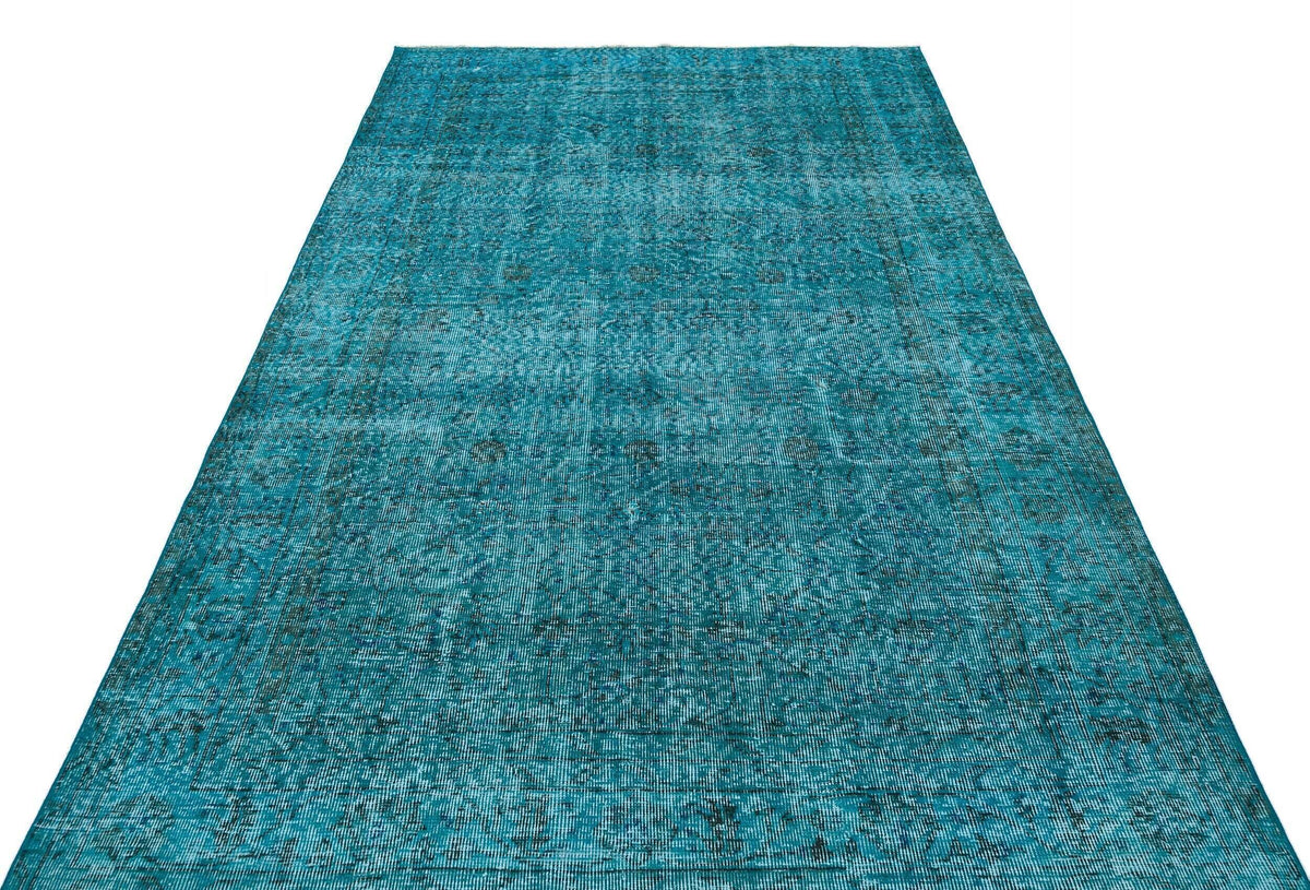Teal distressed vintage-style rug with a faded traditional medallion pattern on a white background.
