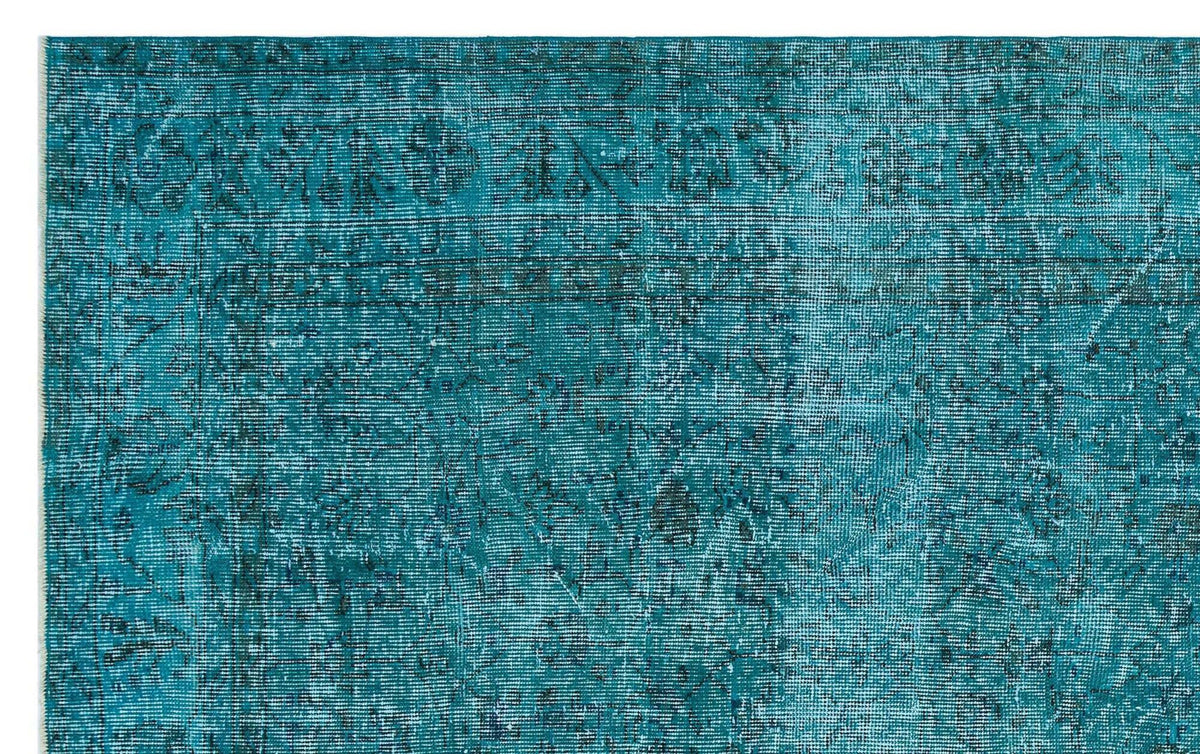 Teal distressed rug with a faded traditional medallion pattern on a white background.