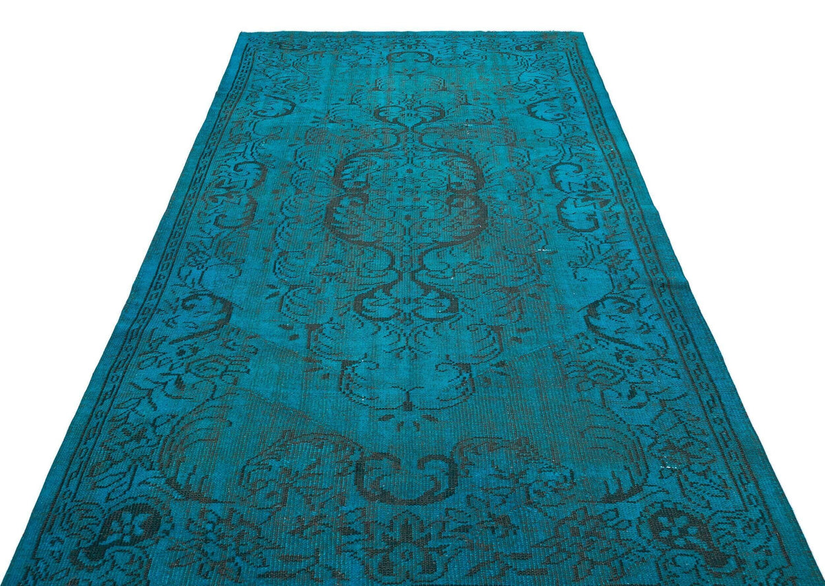 Teal and black distressed rug with a traditional ornate medallion pattern on a white background.