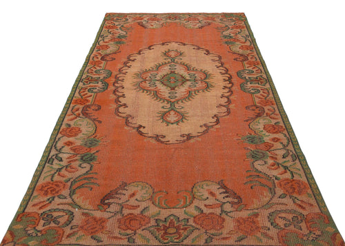 Load image 1 in gallery view. Orange and beige vintage-style rug with a central floral medallion and a decorative floral border.
