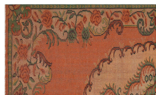 Load image 1 in gallery view. Terracotta rug with a green and orange floral border and a central medallion pattern.