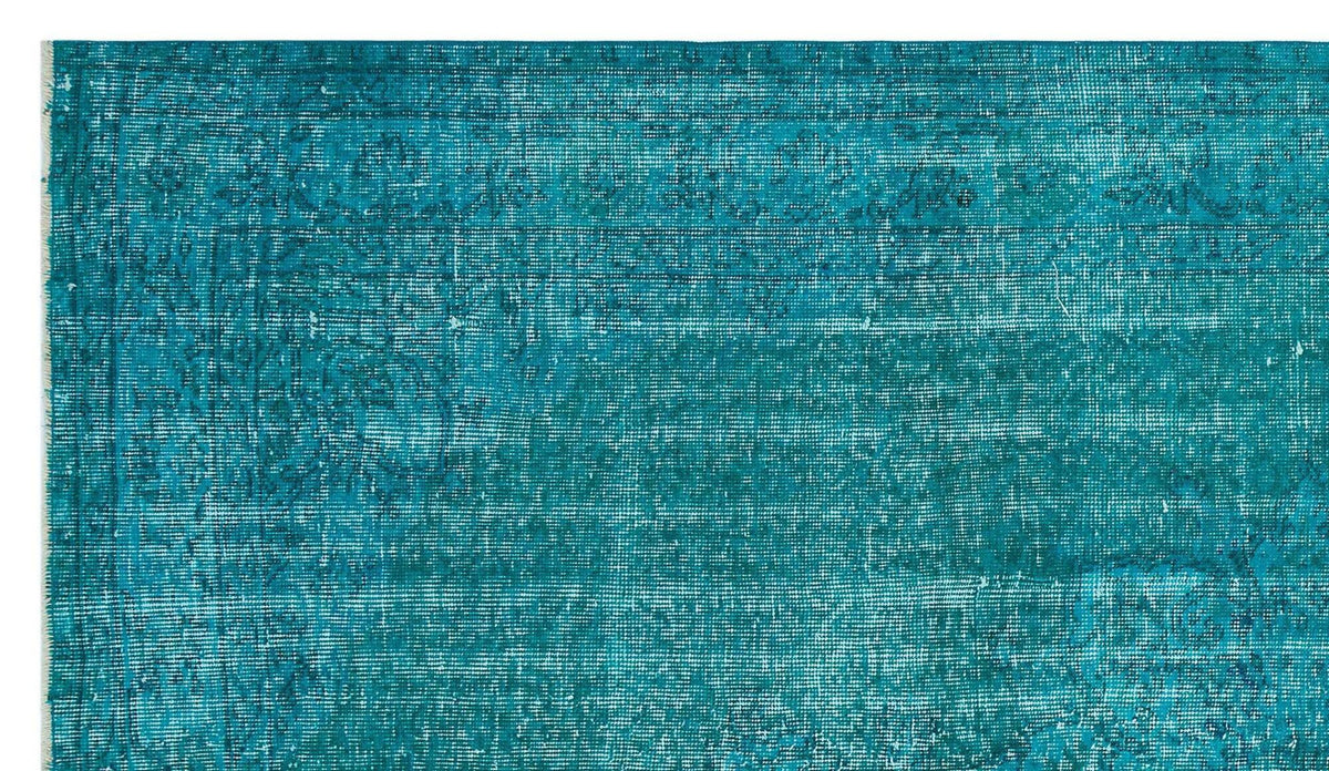 Teal distressed vintage-style rug with a faded traditional medallion pattern and white fringe edge.