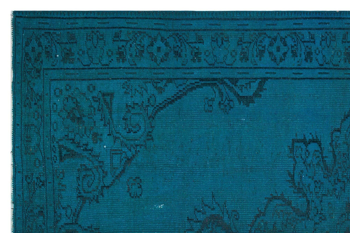 Teal rug with a dark blue traditional floral border and corner medallion pattern on a white background.