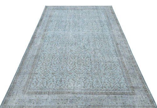 Load image 1 in gallery view. Light blue and grey distressed rug with a traditional floral medallion pattern on a white background.