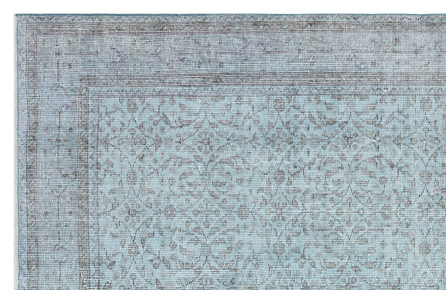Load image 1 in gallery view. Light blue and charcoal grey rug with a traditional distressed floral medallion pattern and a wide border.