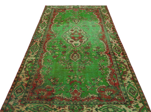 Load image 1 in gallery view. Distressed green, red, and beige vintage-style rug with a central floral medallion and ornate border.