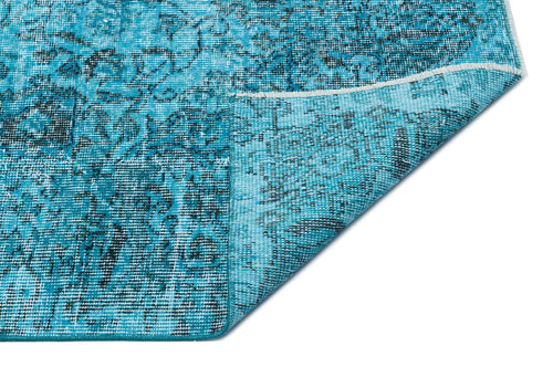 Load image 1 in gallery view. Turquoise and black distressed medallion pattern rug with a folded corner on a white background.