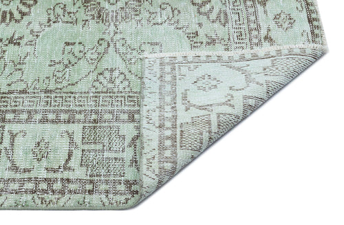 Load image 1 in gallery view. Sage green and brown distressed traditional rug with a folded corner showing the underside texture.