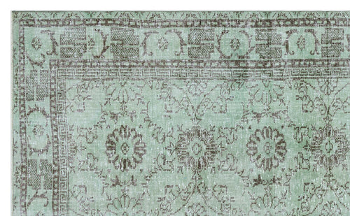 Load image 1 in gallery view. Mint green and brown distressed rug with a traditional floral medallion pattern and geometric border.