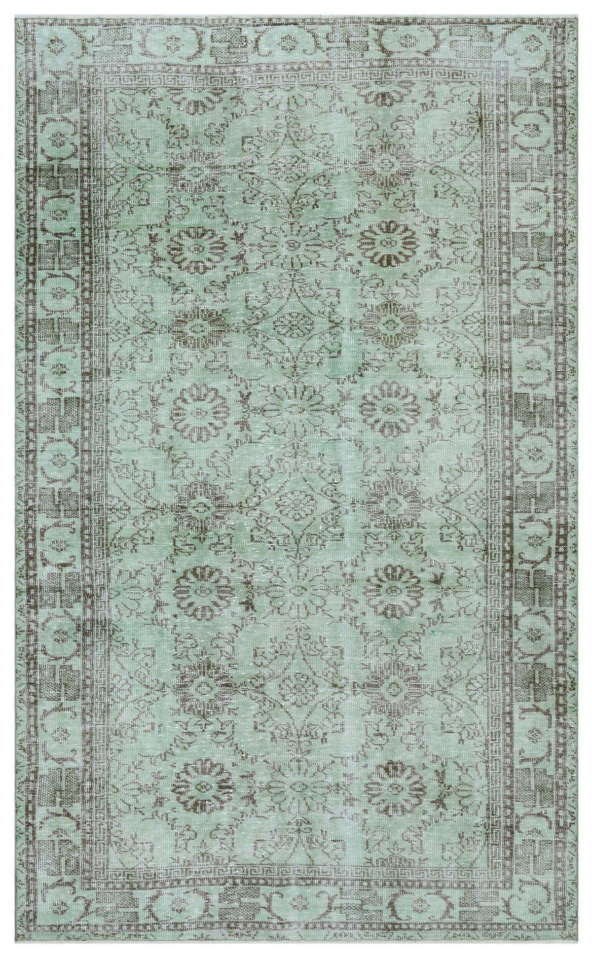 Sage green and brown traditional rug with a distressed floral medallion pattern and a geometric border.