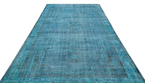 Load image 1 in gallery view. Distressed turquoise and black overdyed rug with a traditional medallion pattern on a white background.