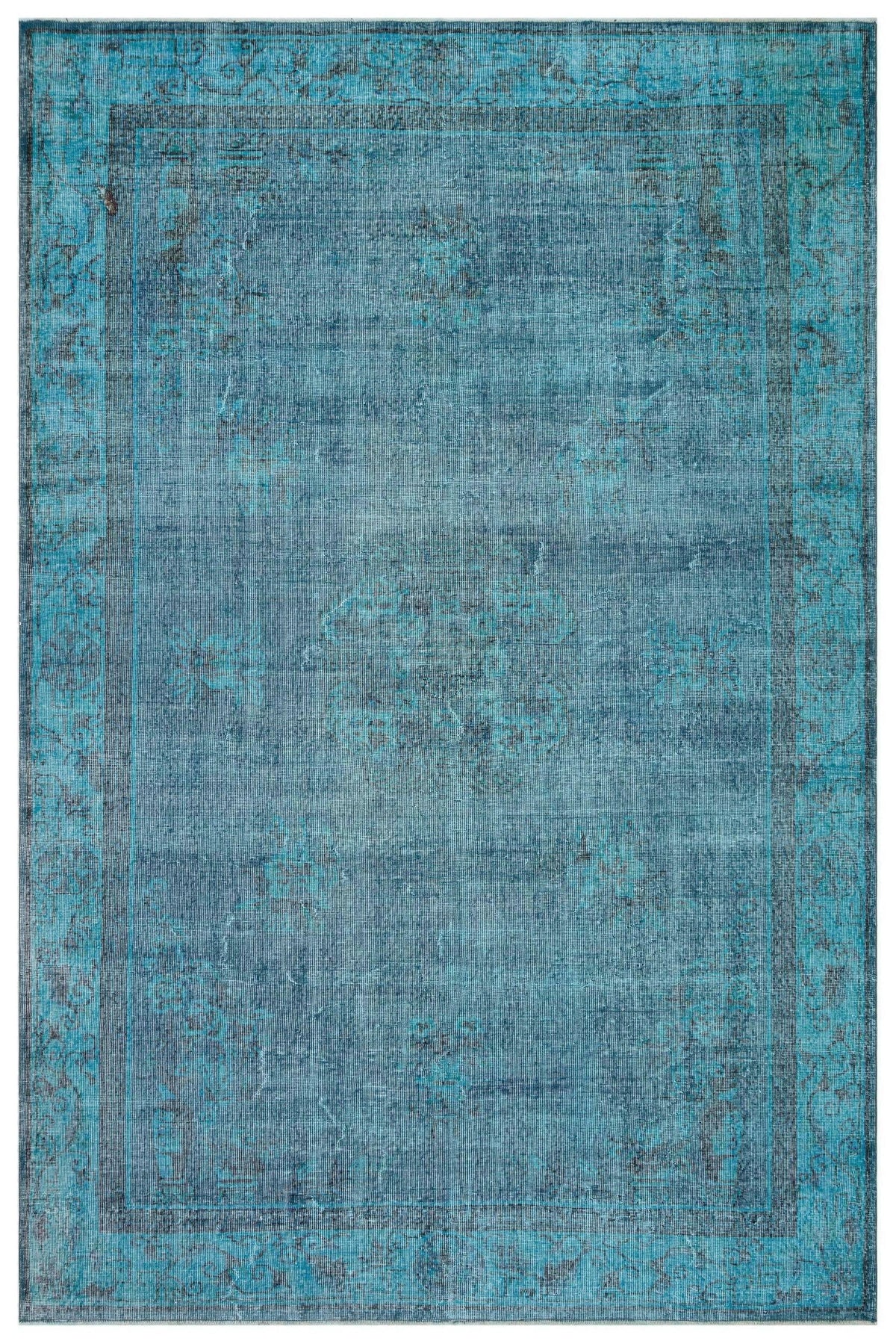 Teal and navy blue distressed traditional rug with a faded central medallion and ornate border.