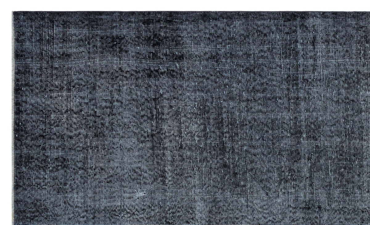 Charcoal and black distressed rug with a faded, textured vintage-style weave.