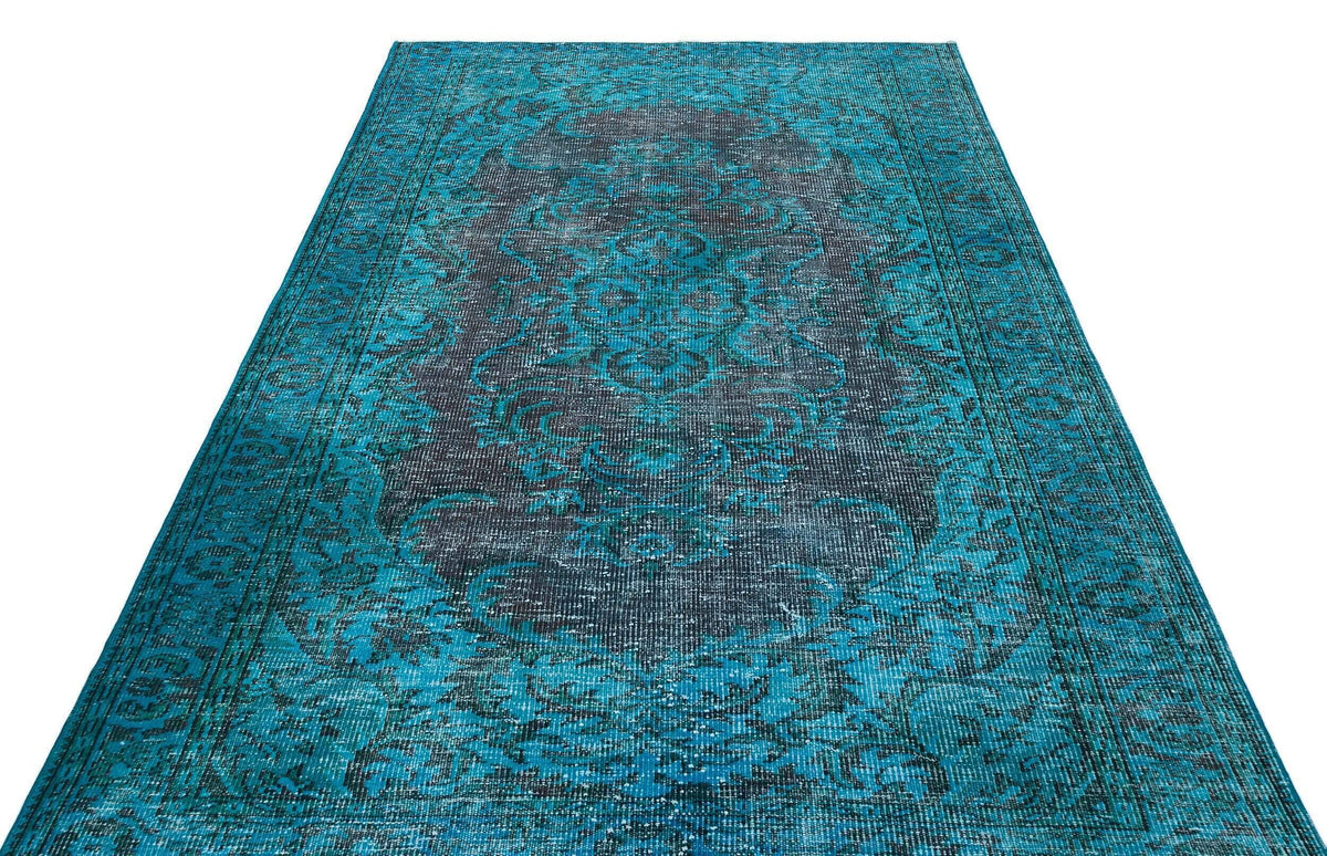 Teal and charcoal distressed area rug with a traditional central medallion and ornate border pattern.