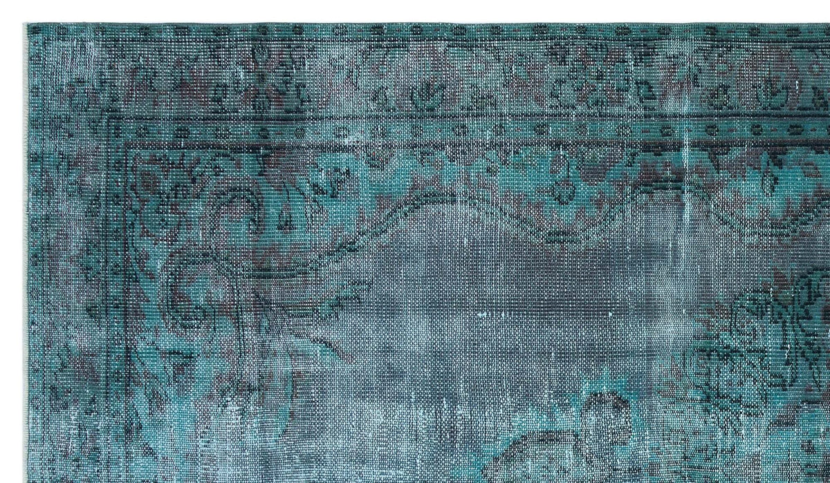 Teal and charcoal distressed rug with a traditional ornate floral border and medallion pattern.