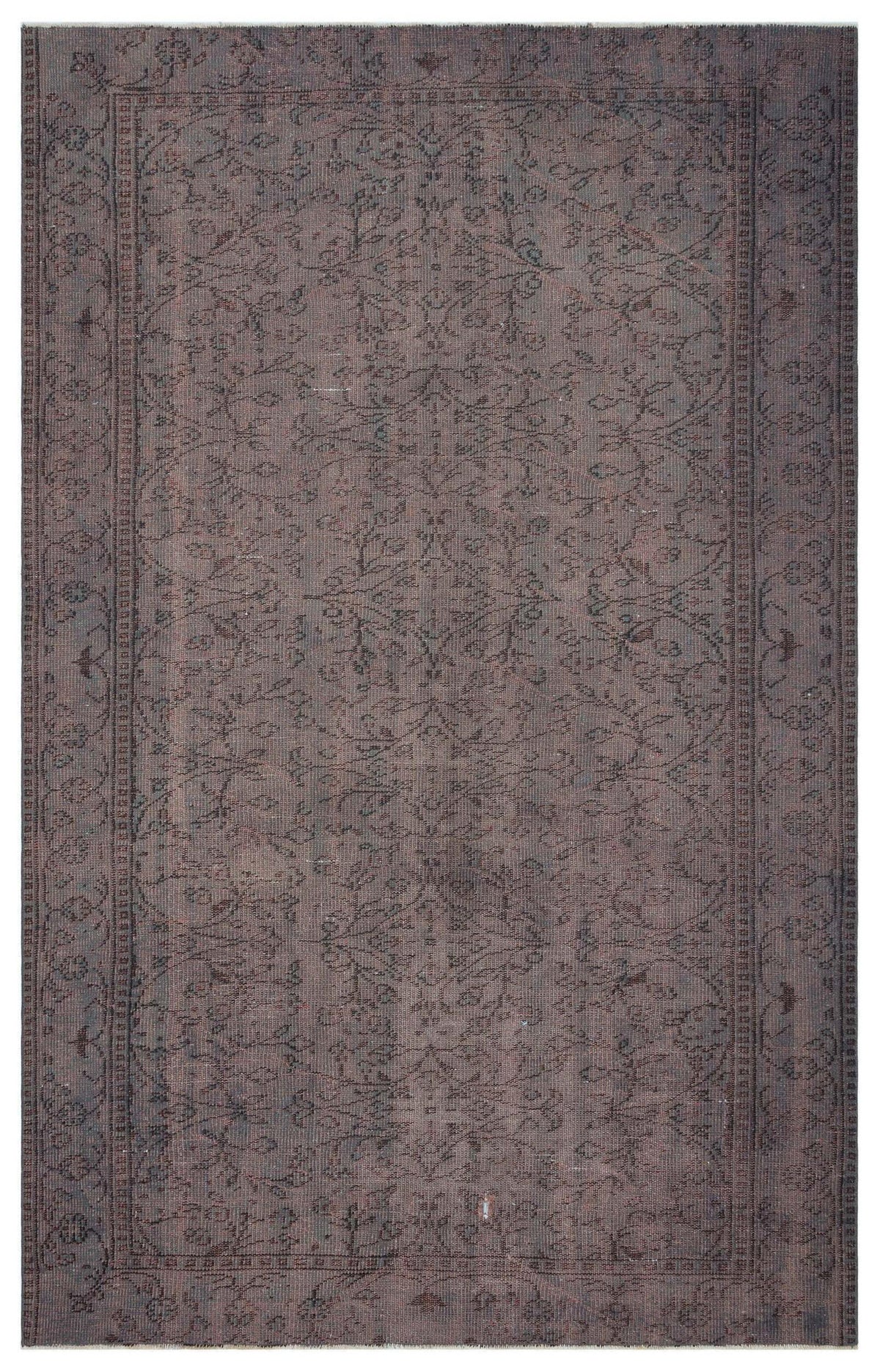 Dark brown vintage-style rug with a faded floral medallion pattern and a detailed border.