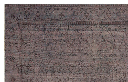 Load image 1 in gallery view. Dark charcoal and brown distressed rug with a traditional floral border and central vine pattern.