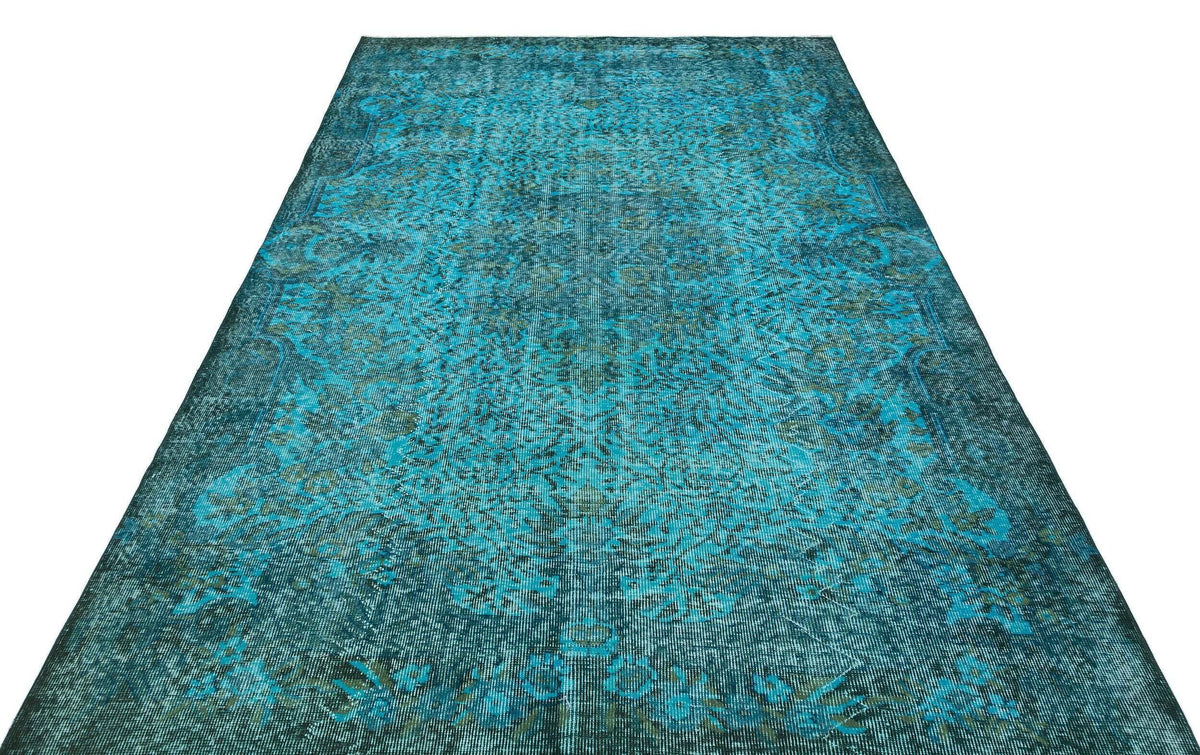 Teal and dark green distressed vintage-style rug with a traditional floral medallion pattern on a white background.