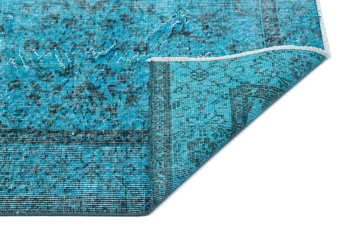 Load image 1 in gallery view. Bright turquoise rug with a distressed black traditional medallion pattern, shown with a folded corner on white.