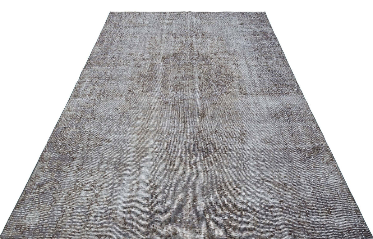 Grey and white distressed vintage-style rug with a faded traditional medallion pattern on a white background.